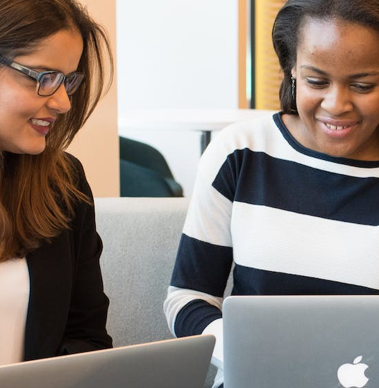 three woman in front of laptop computer